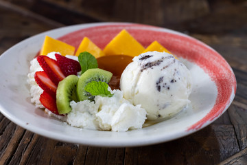 Pudding and ice cream with fresh fruit.