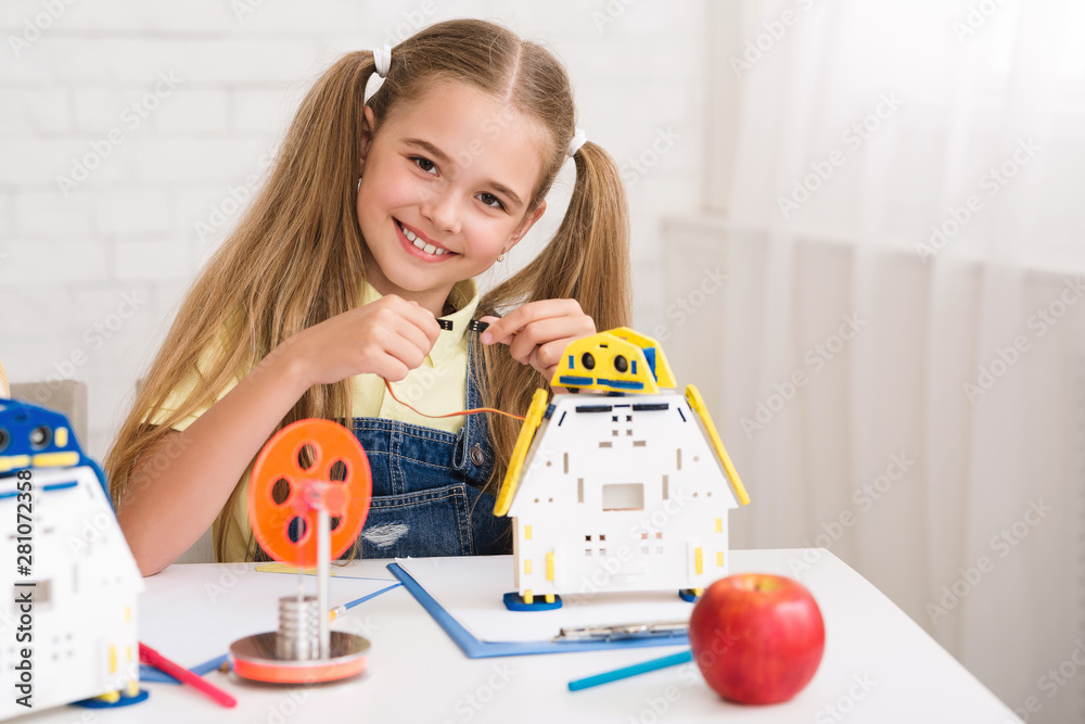 Poster stem education. happy girl constructing robot at lesson