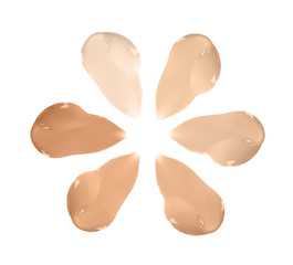 Set with smears of different foundations on white background