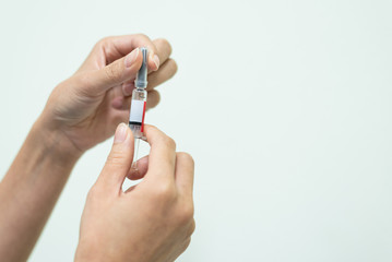 Close up doctor's hand holding syringe for vaccine to patient on white background.Nurse using syringe are vaccination to patient for influenza protection.Medication treatment concept.