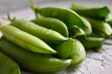 many of Green Pea Pods on factured surface