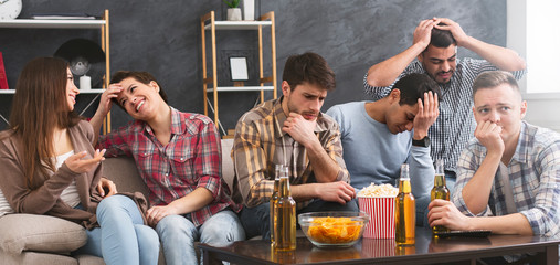 Four male friends frustrated after watching football game