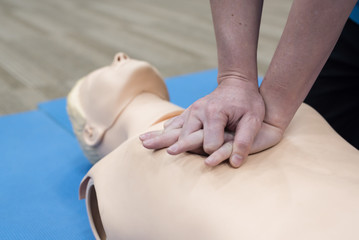 Demonstrating CPR (Cardiopulmonary resuscitation) training medical procedure on CPR doll in the class.Doctor and nurse students are learning how to rescue the patient.First aid for safe life concept.