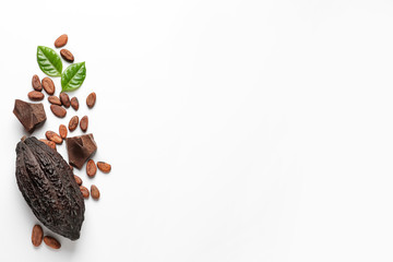 Cocoa pod with beans and chocolate pieces on white background, top view - obrazy, fototapety, plakaty