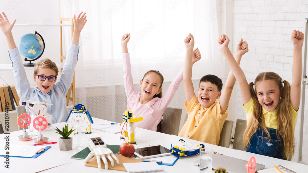 Poster happy children with raised hands after robotics class
