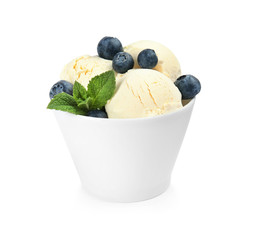 Delicious vanilla ice cream with blueberries and mint in dessert bowl on white background