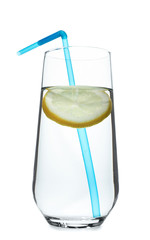 Glass of water with lemon and straw on white background. Refreshing drink