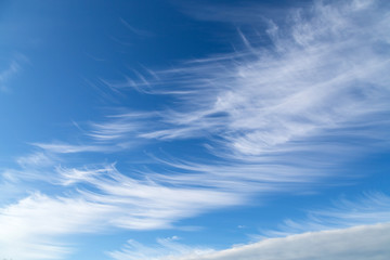 Beautiful blue sky with white fancy clouds