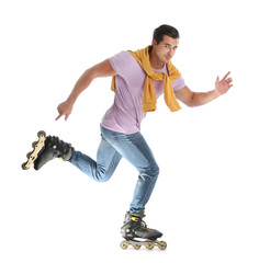 Handsome young man with inline roller skates on white background