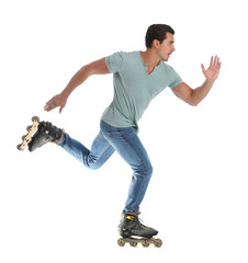 Handsome young man with inline roller skates on white background
