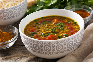Indian lentil soup dal (dhal) in a bowl on wooden table