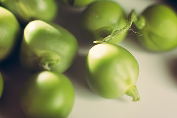 Fresh green appetizing peas on a white background.