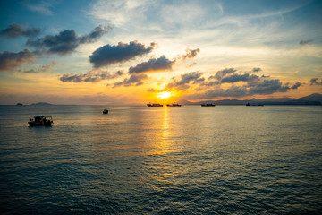 Obraz premium Fishing boats on sea in sunset lights in Sanya, Hainan, China