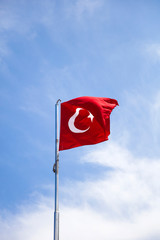 Turkish flag waving in the wind at blue sky