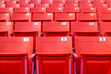 Fototapeta premium Row of red folding chairs in a stadium. Sport concept.