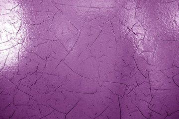 Cracked paint texture in purple color.