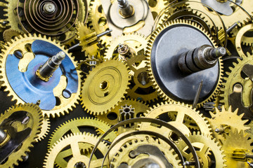 Background of bronze gears from the clock close-up.
