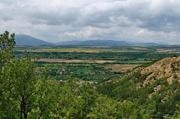 Fototapeta na wymiar A view from path on the slope of the Stob Pyramids to the valley of the village of Stob, Rila mountain, Kyustendil region, Bulgaria, Europe 