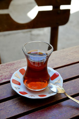 a glass of Turkish tea on wooden table
