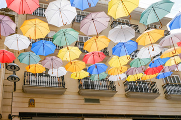 Fototapeta na wymiar Street covered by colored umbrellas