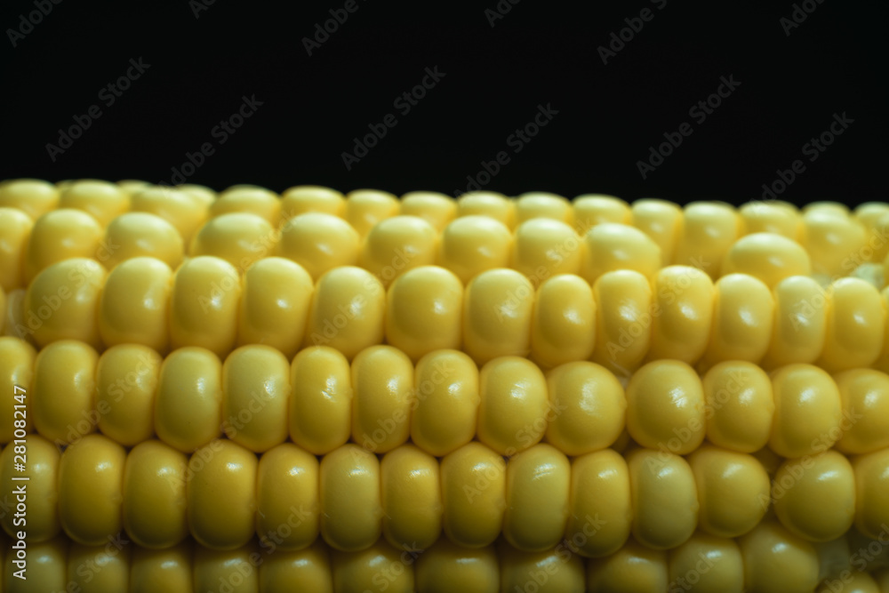 Poster close up beautiful fresh corn maze on a black background. macro view.