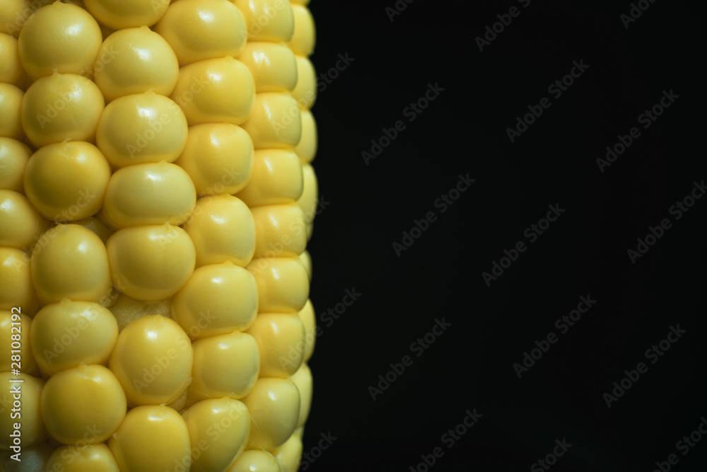 Poster close up beautiful fresh corn maze on a black background. macro view.