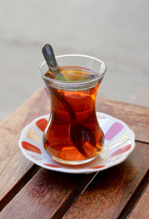 a glass of Turkish tea on wooden table