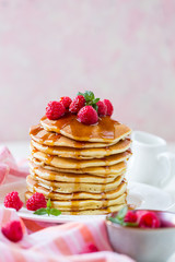 Homemade pancakes with maple syrup and  raspberries