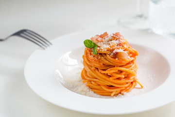 Homemade Amatriciana - Italian pasta based on guanciale (cured pork cheek), pecorino cheese, tomato, white wine, olive oil. Cucina romana tradizionale. Original recipe fixed by Comune di Amatrice.