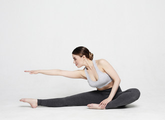 Fototapeta na wymiar Portrait of attractive woman doing yoga, pilates. Healthy lifestyle and sports concept.