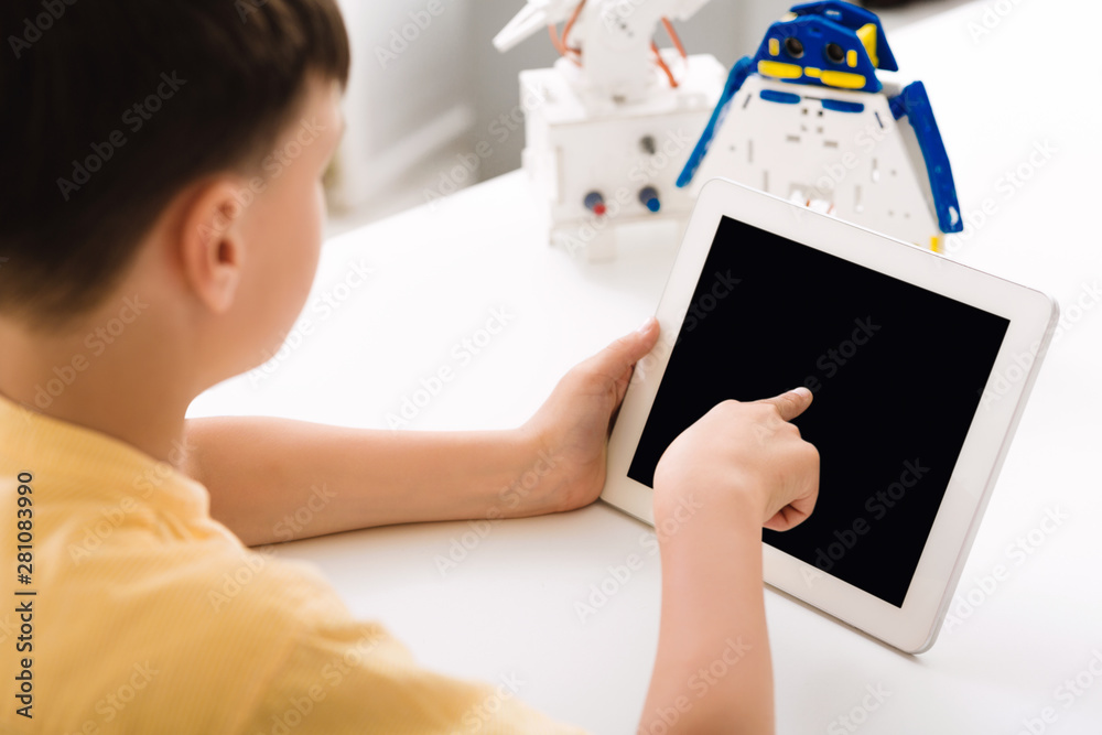 Poster boy programming electric toy with tablet computer