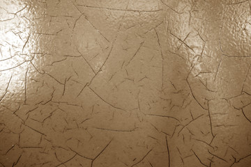 Cracked paint texture in brown color.