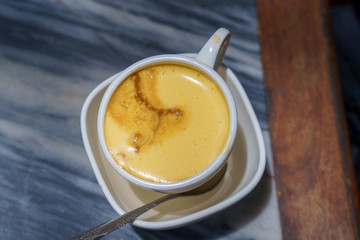 Vietnamese egg coffee hot and cool in the white coffee mug, cup in HANOI VIETNAM
