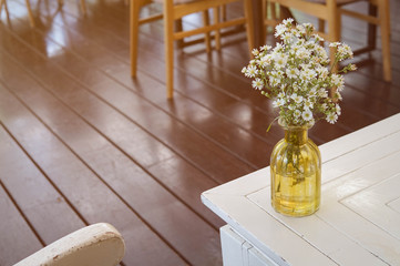 flowers in a vase on the table in morning of coffee shop