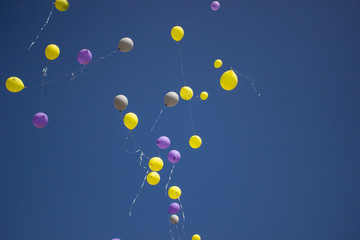 Balloons in the sky. Festive balloons fly through the air. Many balloons filled with helium and released up. Festive background.