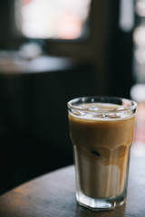 cappuccino or Latte ice coffee made from milk on the wood table in coffee shop