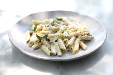 Penne pasta with white sauce and truffle , italian food