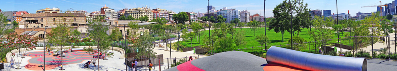 Fototapeta na wymiar Parque infantil y jardines en la plaza de Les Glories de Barcelona, Catalunya, España, Europa