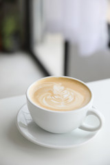 cappuccino or Latte art coffee made from milk on the wood table in coffee shop