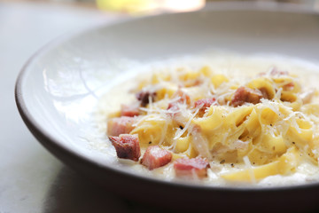 fettuccine carbonara , fettuccine pasta spaghetti with bacon ham and mushroon in white sauce italian food