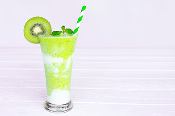 Kiwi yogurt juice healthy smoothies green beverage taste delicious drink summer have proten colorful in the glass and fruit kiwi  on white wood background.