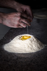 Kneading dough on the kitchen and cooking pizza with cheese Mozzarella