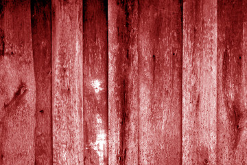 Weathered wooden fence in red color.