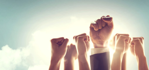 Hands of Business team raised fist air Corporate Celebration victory, success and winning concept. sunlight effect, copy space.