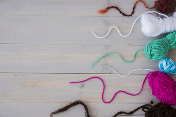 An overhead view of wool balls on weathered wooden desk