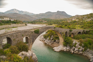 Fototapeta na wymiar Mesi Bridge. Ottoman bridge crosses the Kir River near the village of Mes. Albania, Shkoder County