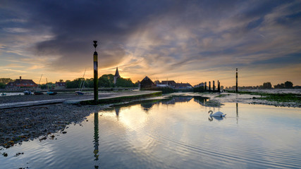 Summer sunrise over the Holy Trinity Church and Bosham Quay in West Sussex, UK