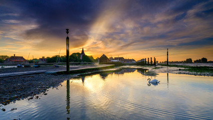 Summer sunrise over the Holy Trinity Church and Bosham Quay in West Sussex, UK