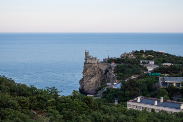 Fototapeta na wymiar Castle Swallow Nest on a rock in the Black Sea. Yalta, Crimea, Russia. . Beautiful view of the Swallow Nest on a cliff in summer