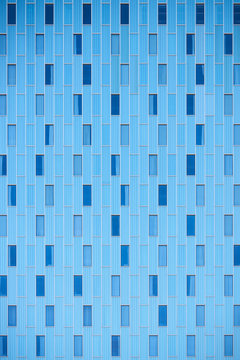 Blue facade of modern building with windows